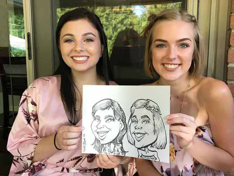 Two young women showing a caricature of themselves.