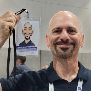 Trade show attendee holding their caricature print